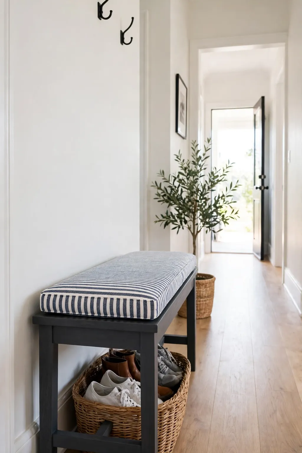 Entryway bench painted charcoal with a striped cushion in a hallway