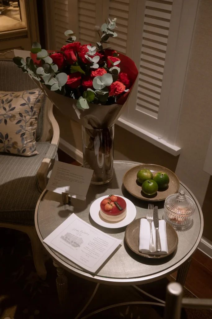Small thrifted side table beside a dining table used as a Thanksgiving serving station